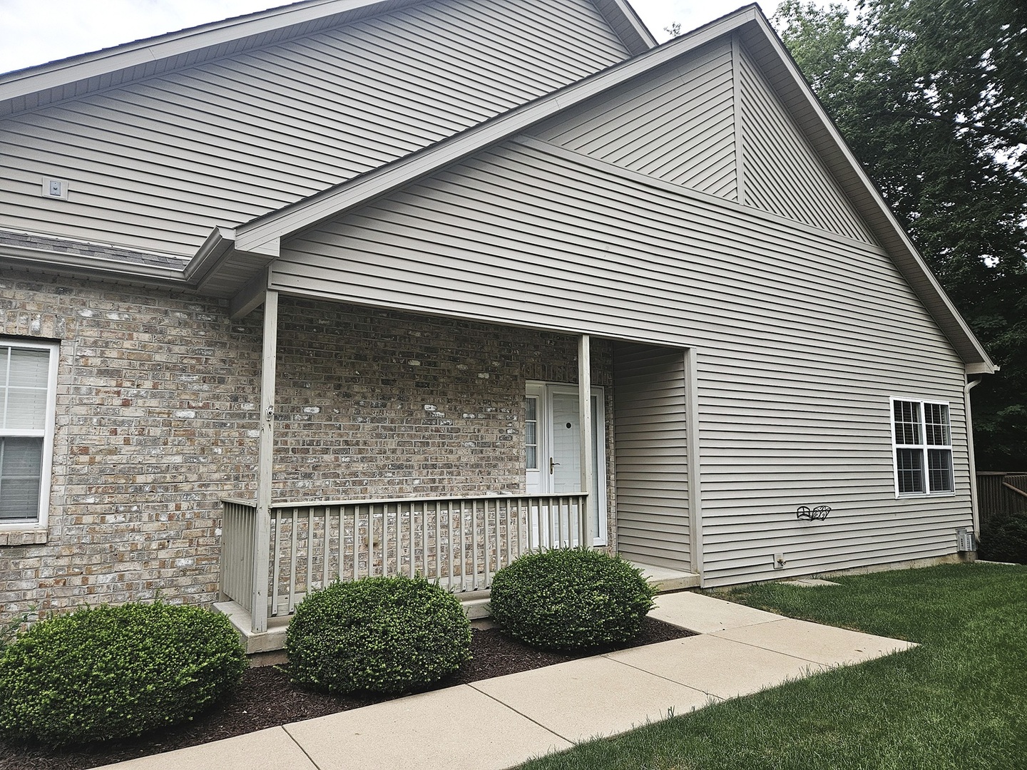 1670 Overlook Drive Dixon, IL 61021 - Photo 36 of 36 a view of a white house with a yard and plants