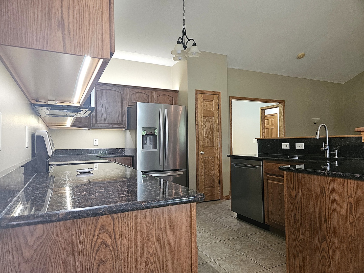 1670 Overlook Drive Dixon, IL 61021 - Photo 6 of 36 a kitchen with granite countertop a sink and stainless steel appliances
