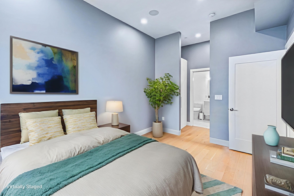 20 West Fifth Street, Unit 5E Boston, MA 02127 - Photo 16 of 42 a bedroom with a bed and a painting on the wall