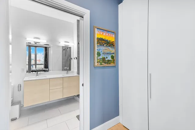 a bathroom with a sink shower and a mirror