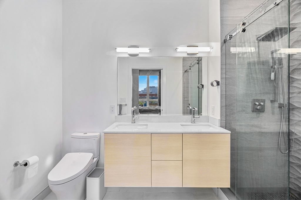 20 West Fifth Street, Unit 5E Boston, MA 02127 - Photo 19 of 42 a bathroom with a sink toilet and shower