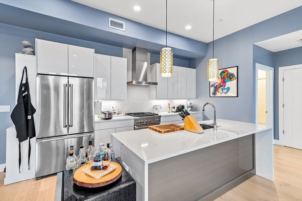 20 West Fifth Street, Unit 5E Boston, MA 02127 - Photo 4 of 42 a kitchen with stainless steel appliances granite countertop a sink a refrigerator and a stove