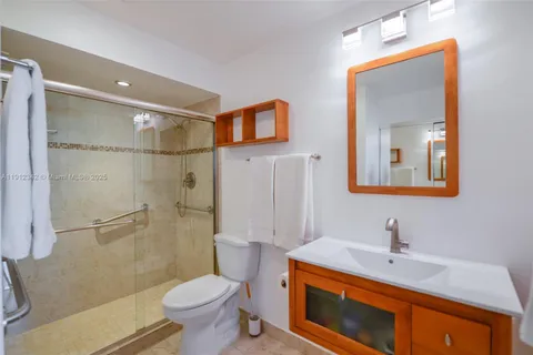 a bathroom with a sink toilet and shower