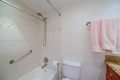 a bathroom with a shower curtain and a toilet