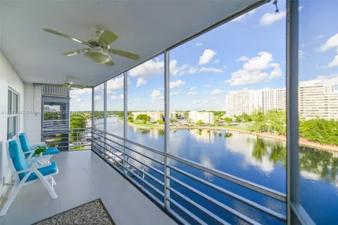 a view of a living room and floor to ceiling window or wooden floor