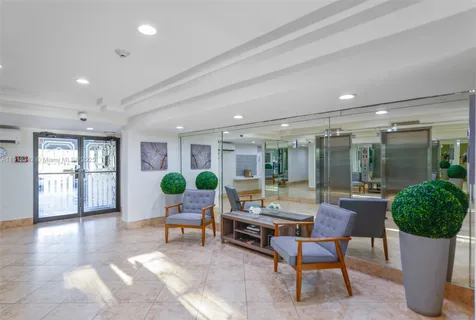 a living room with furniture and potted plants