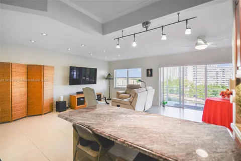 a bedroom with a bed a large window and chair