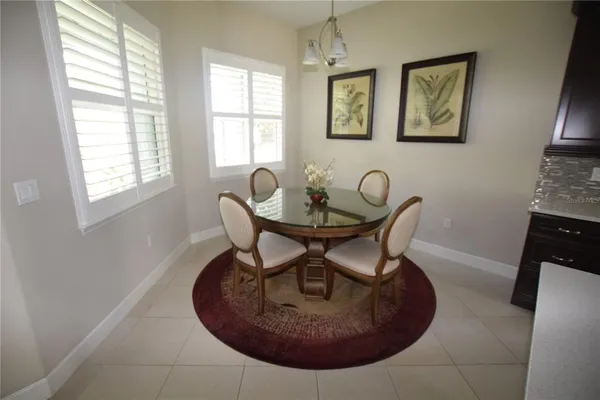 a view of a dining room with furniture and window
