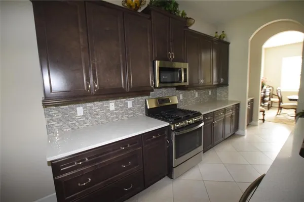 a kitchen with a sink stove and microwave