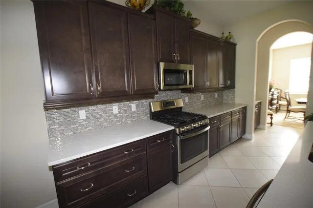 a kitchen with a sink stove and microwave