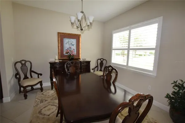 a view of a dining room with furniture and window
