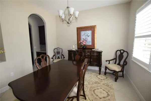 a view of a dining room with furniture and chandelier