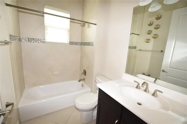 a bathroom with a sink mirror toilet and bathtub