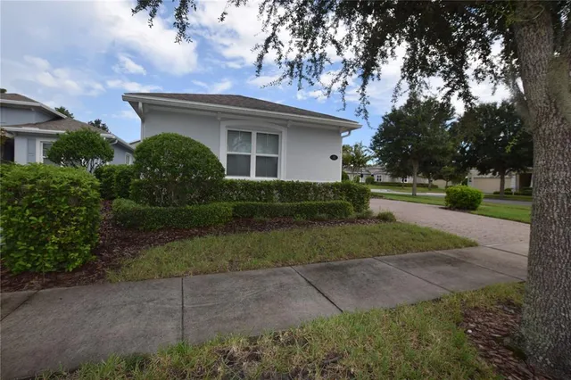 a front view of a house with a yard and trees