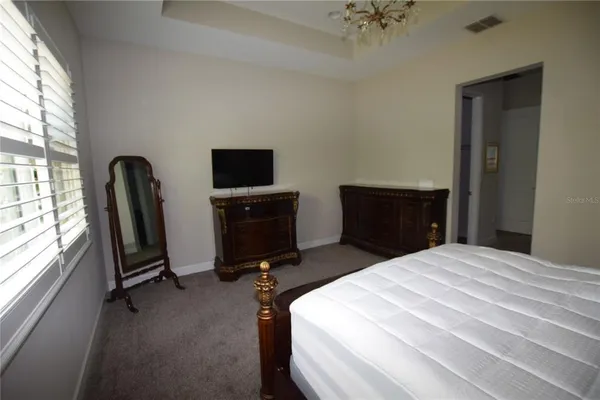 a bedroom with a bed and a television