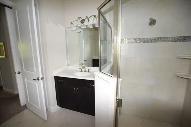 a bathroom with a sink vanity and a mirror