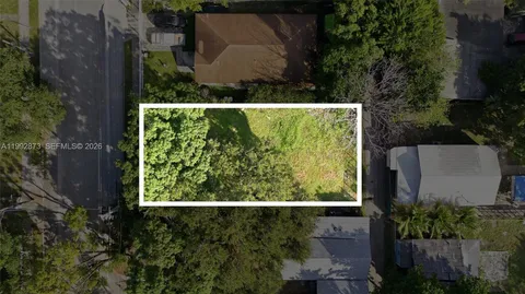 a view of a backyard with large trees
