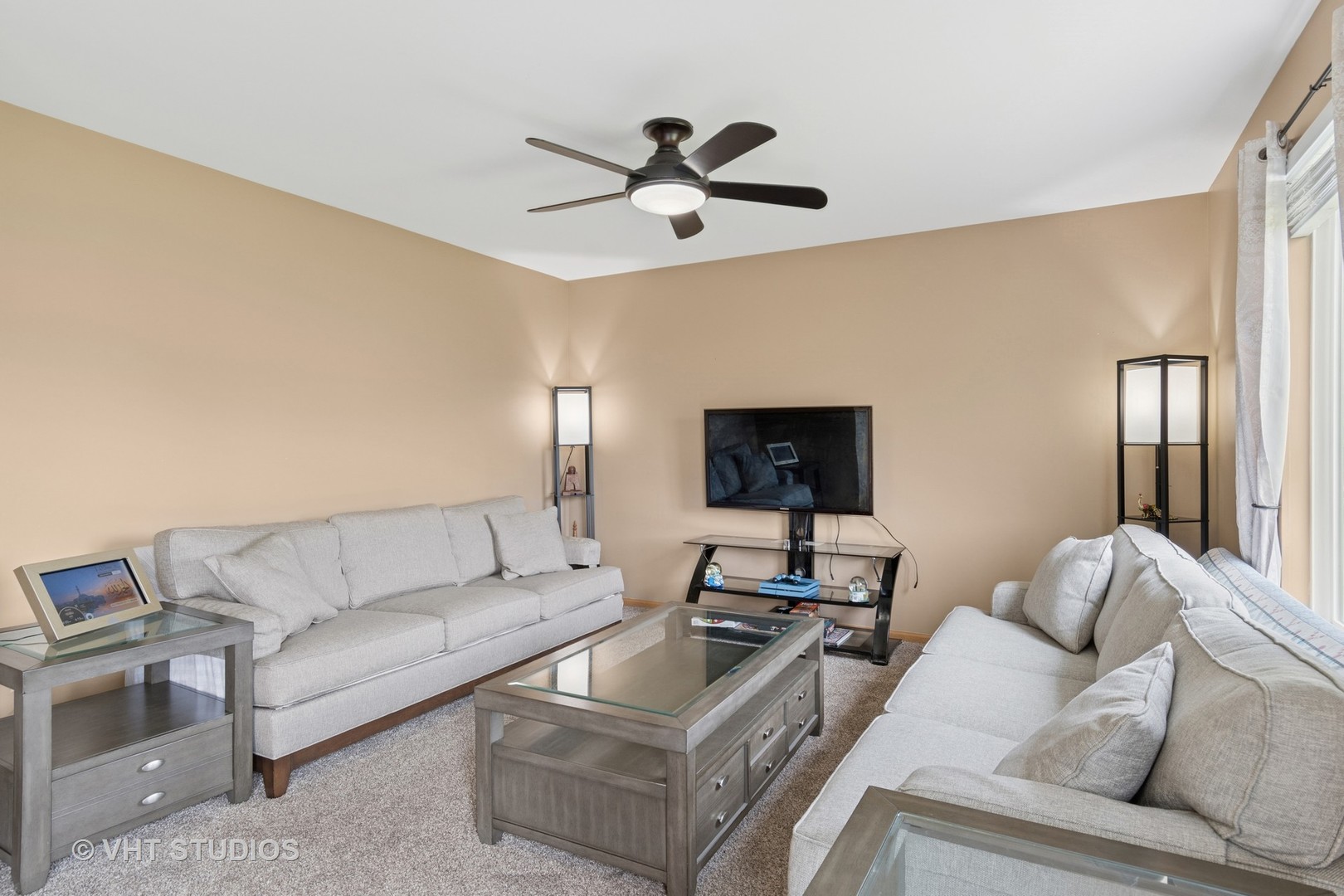 2477 Smithfield Court Aurora, IL 60503 - Photo 8 of 17 a living room with furniture and a flat screen tv