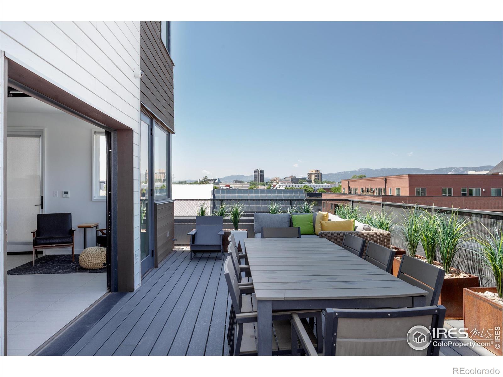 401 Linden Street, Unit 3336 Fort Collins, CO 80524 - Photo 39 of 43 a balcony with wooden floor table and chairs