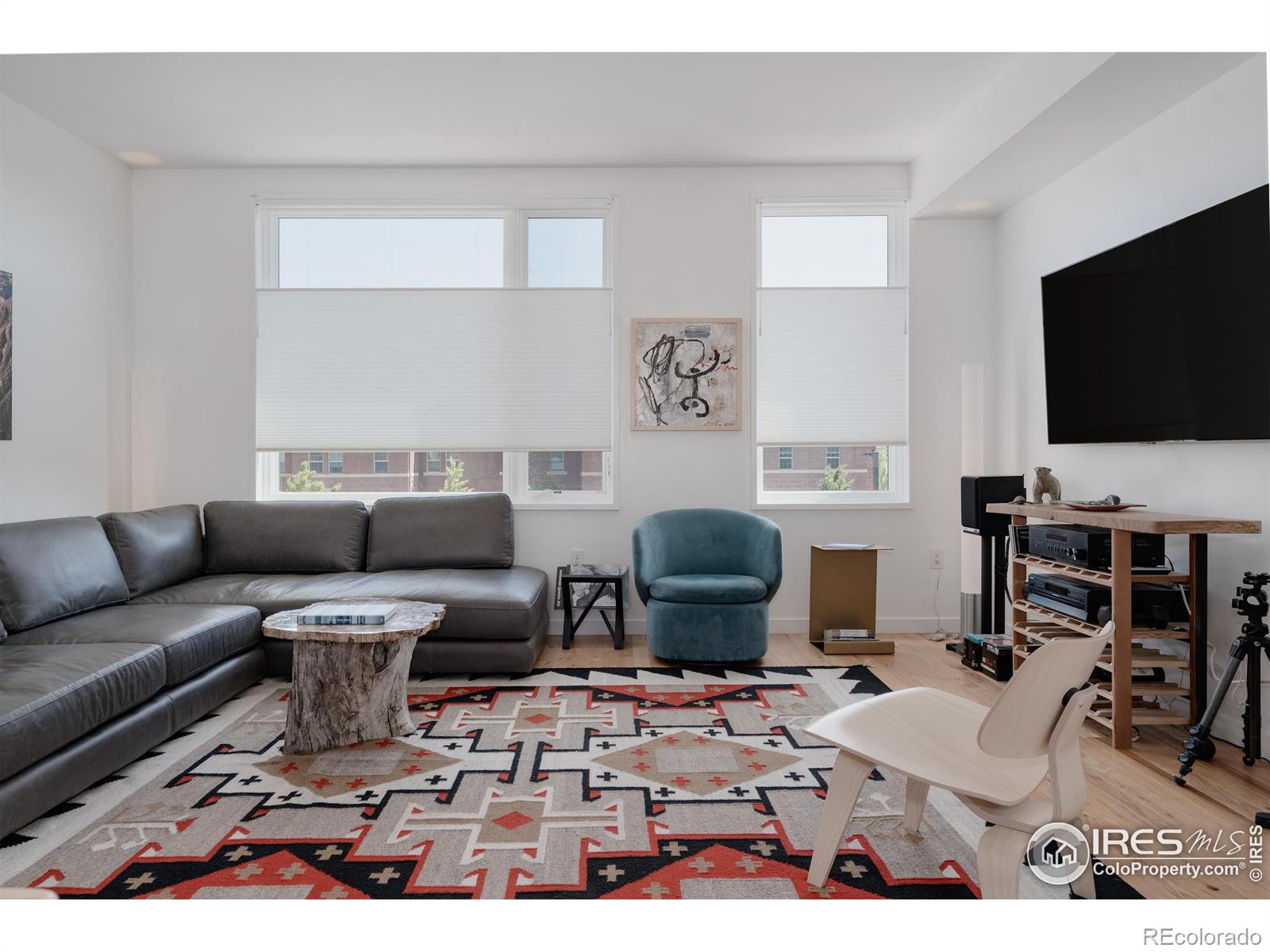 401 Linden Street, Unit 3336 Fort Collins, CO 80524 - Photo 5 of 43 a living room with furniture a flat screen tv and kitchen view