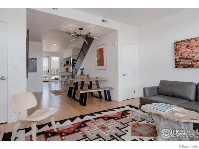 a view of living room with a ceiling fan and a wooden floor