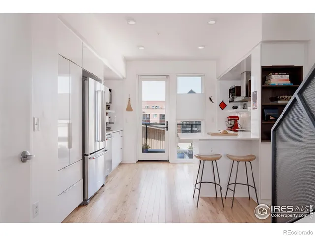a kitchen with stainless steel appliances a sink and a refrigerator