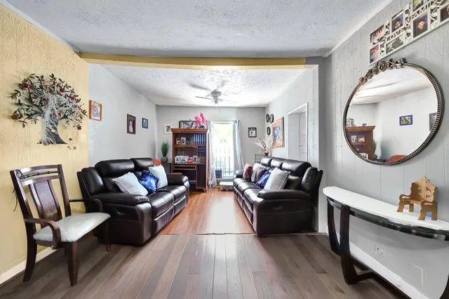 a living room with furniture and a large mirror