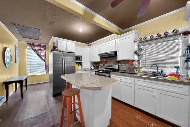 a kitchen with refrigerator and cabinets