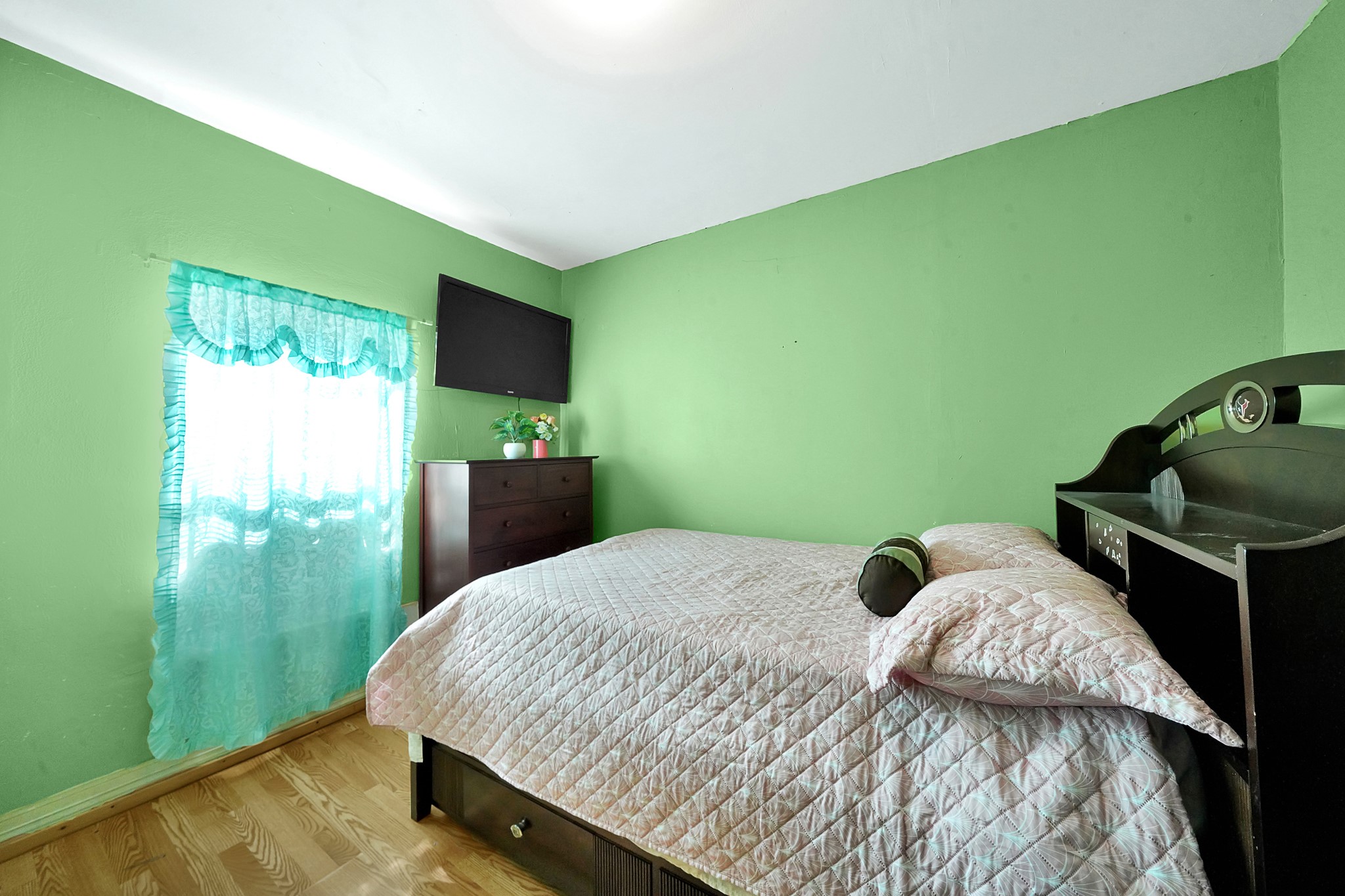 4811 Terry Street Houston, TX 77009 - Photo 22 of 30 a bedroom with a bed and large flat screen tv