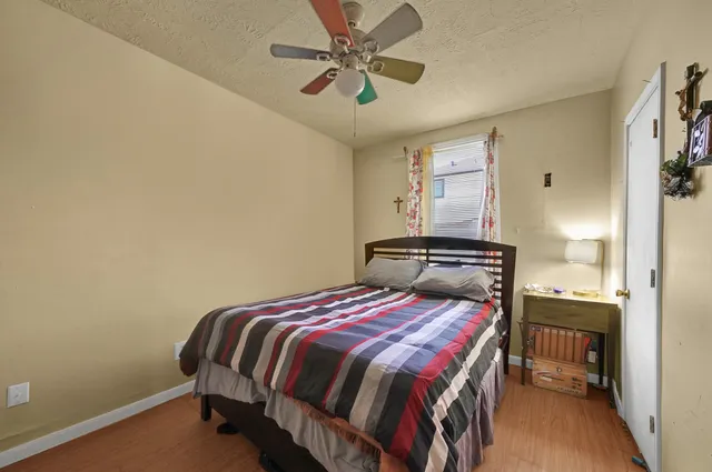 a bedroom with a bed and a chandelier