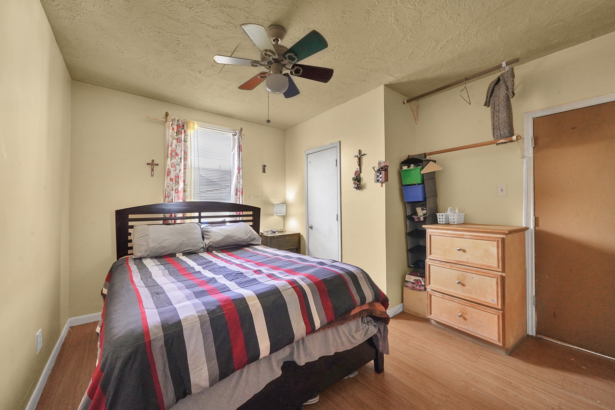 4811 Terry Street Houston, TX 77009 - Photo 9 of 30 a bedroom with a bed and a chandelier