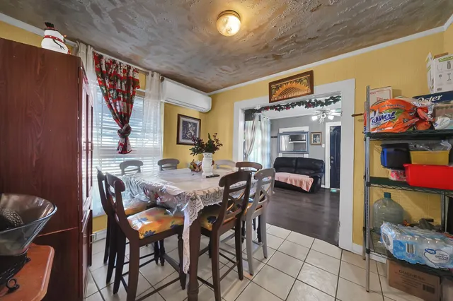 a view of a dining room with furniture and a chandelier