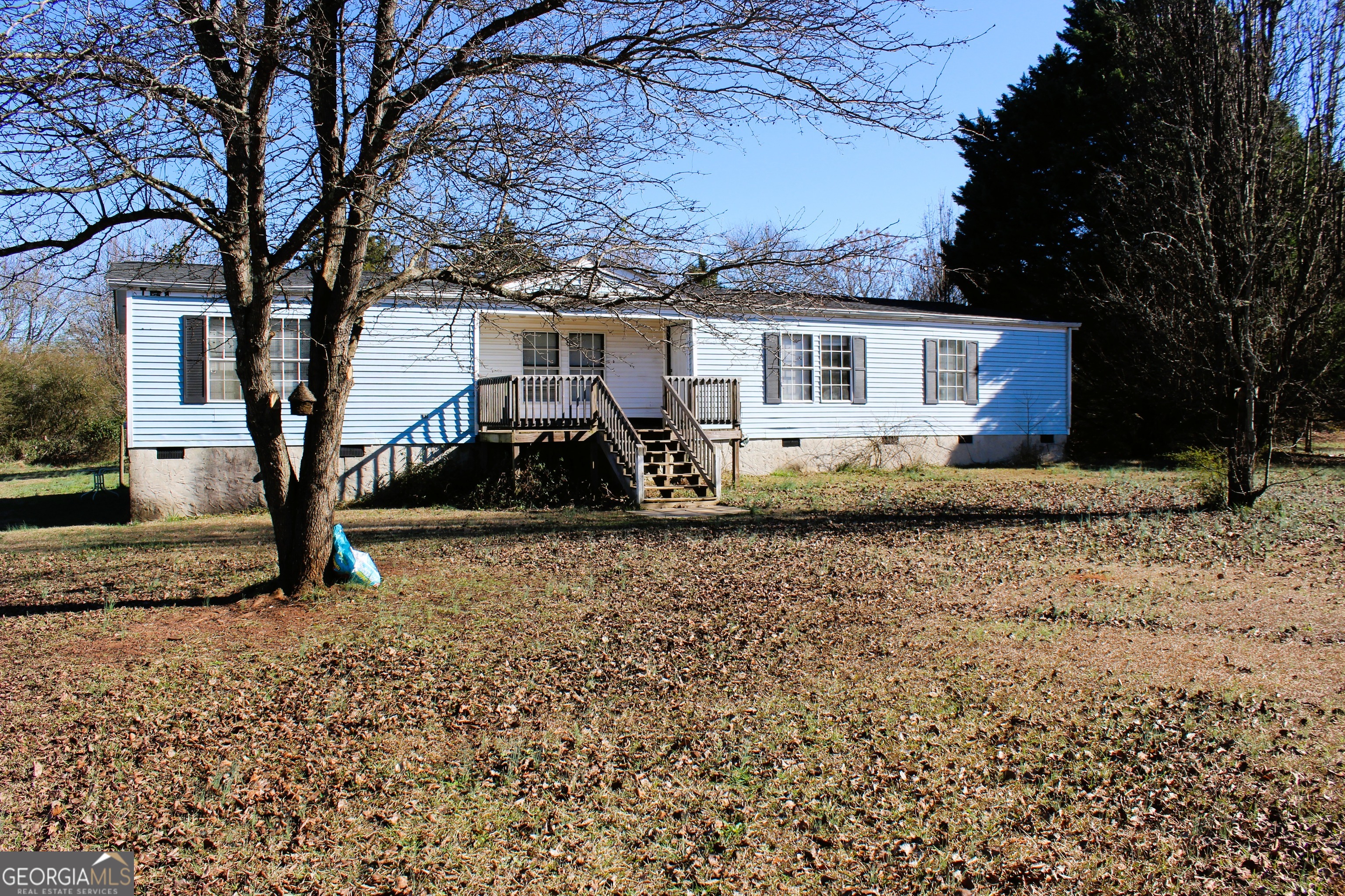 a view of a house with a yard covered in snow