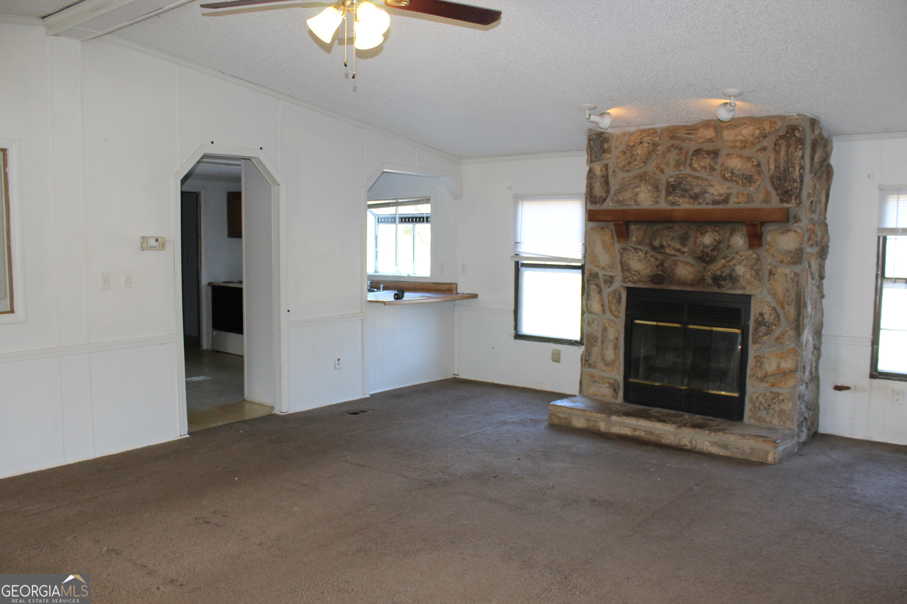 1691 A Rover Zetella Road Williamson, GA 30292 - Photo 12 of 24 a view of an empty room with fireplace and window