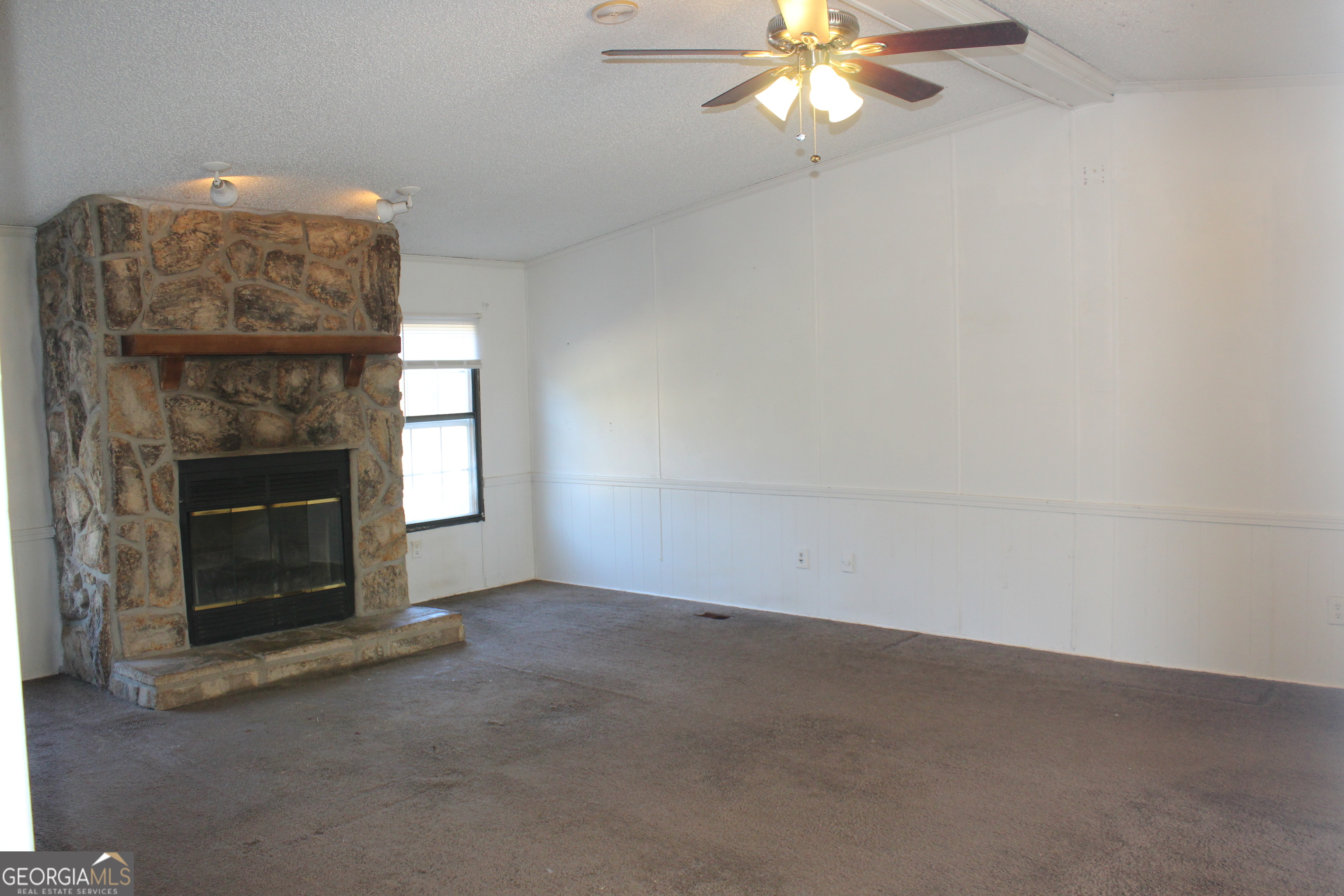 1691 A Rover Zetella Road Williamson, GA 30292 - Photo 13 of 24 an empty room with a fireplace and windows