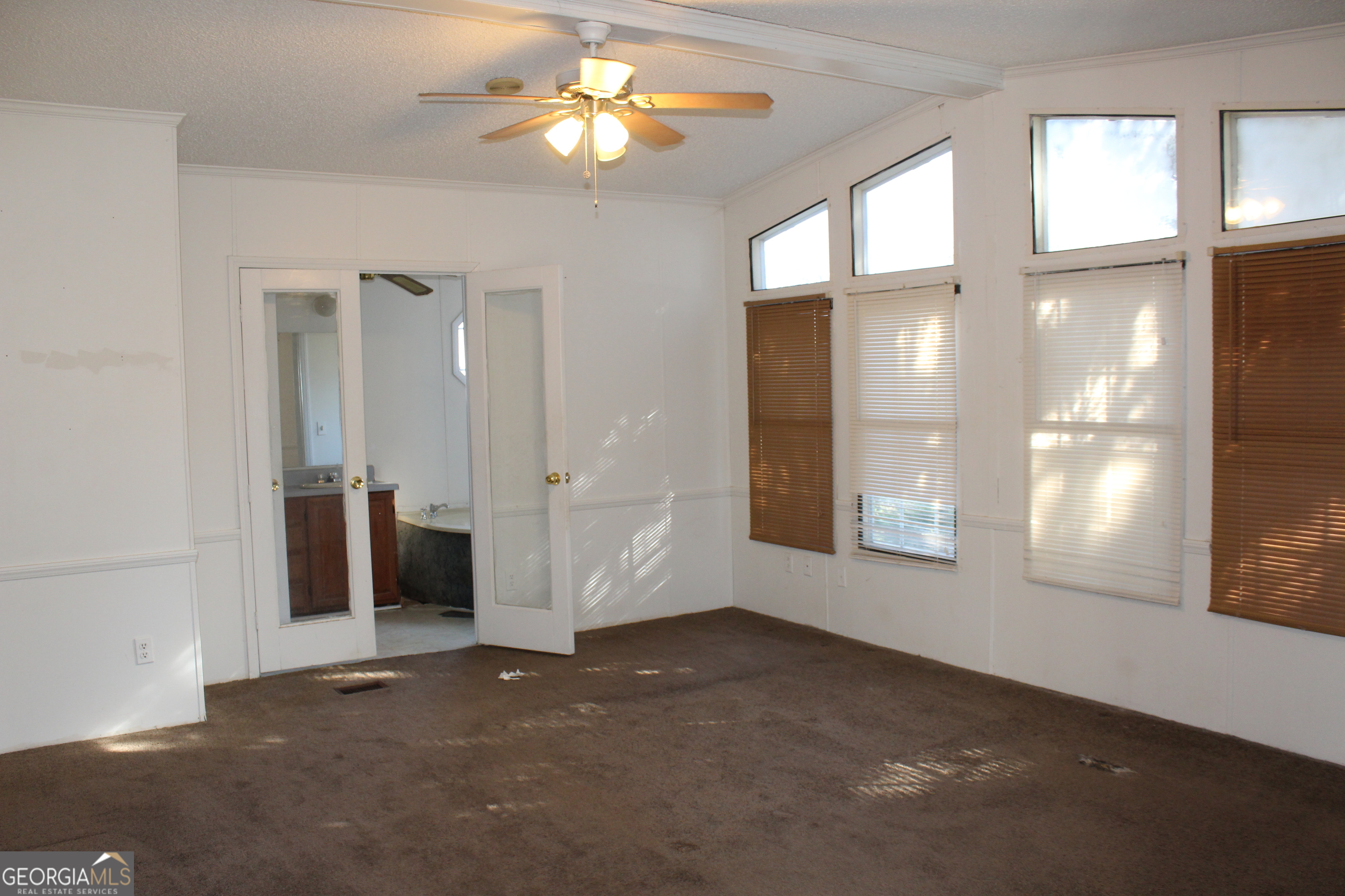 1691 A Rover Zetella Road Williamson, GA 30292 - Photo 14 of 24 an empty room with windows and chandelier fan