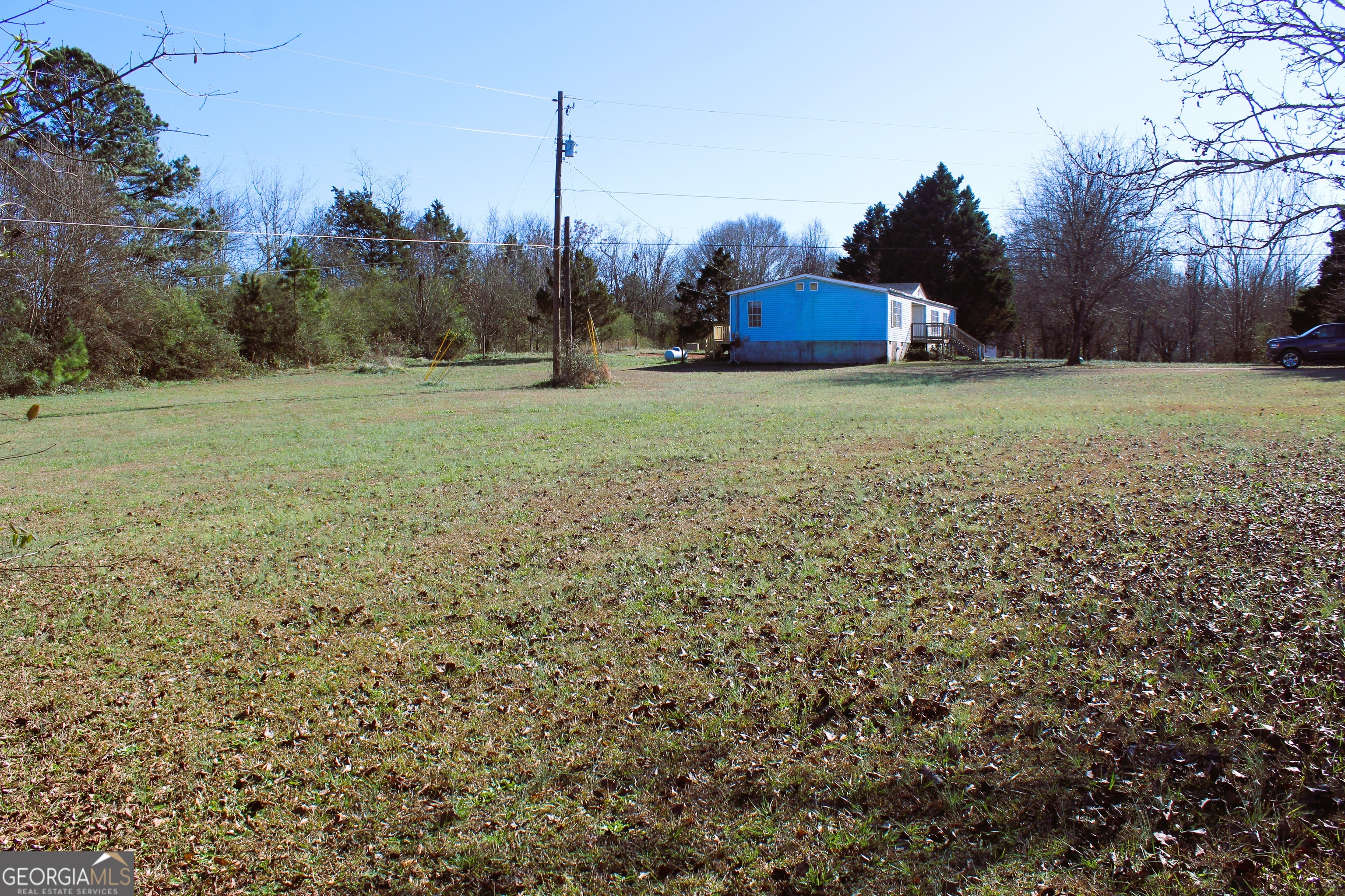 1691 A Rover Zetella Road Williamson, GA 30292 - Photo 5 of 24 a view of a field with large trees