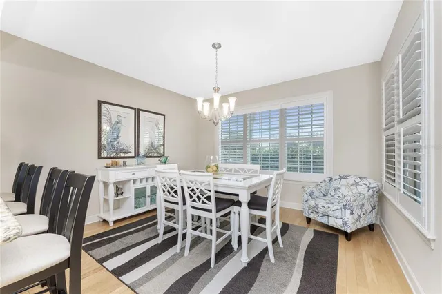 a view of a house with a yard and palm trees
