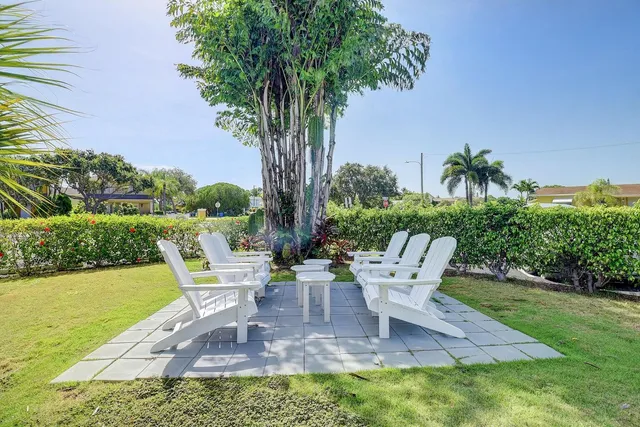 a view of a chair and table on the garden