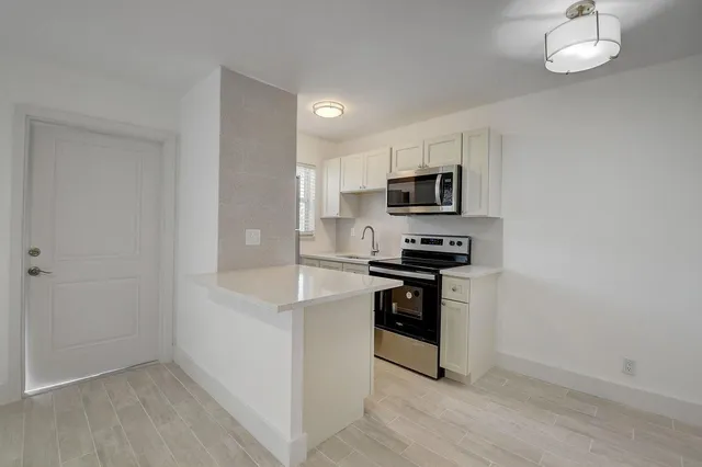 a kitchen with a sink and a stove top oven