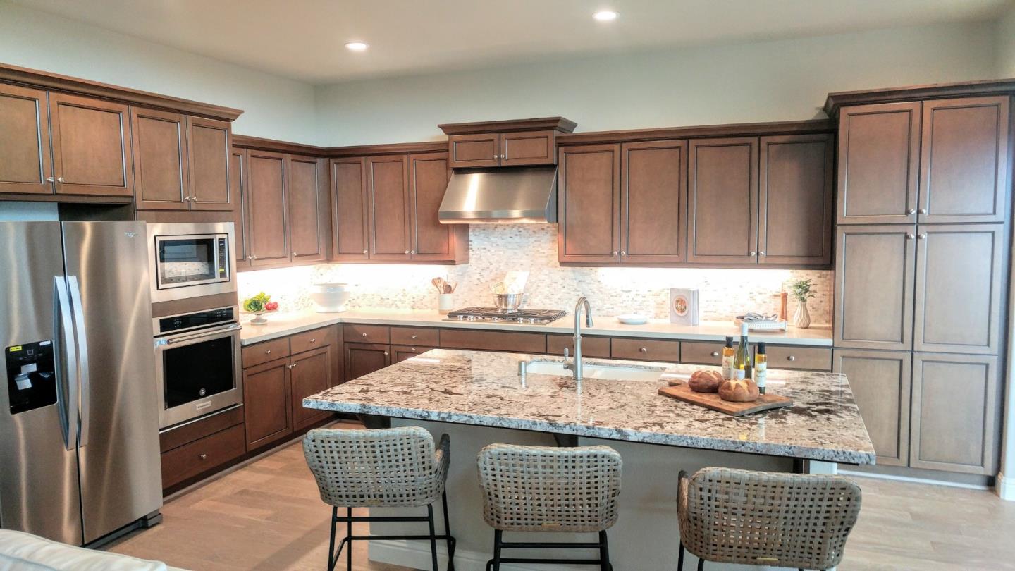 602 Braden Way Marina, CA 93933 - Photo 3 of 13 a kitchen with granite countertop a refrigerator and a stove top oven