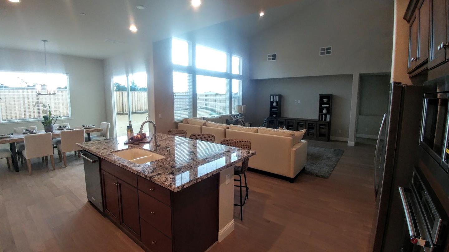 602 Braden Way Marina, CA 93933 - Photo 6 of 13 a living room with stainless steel appliances granite countertop sink a table and chairs