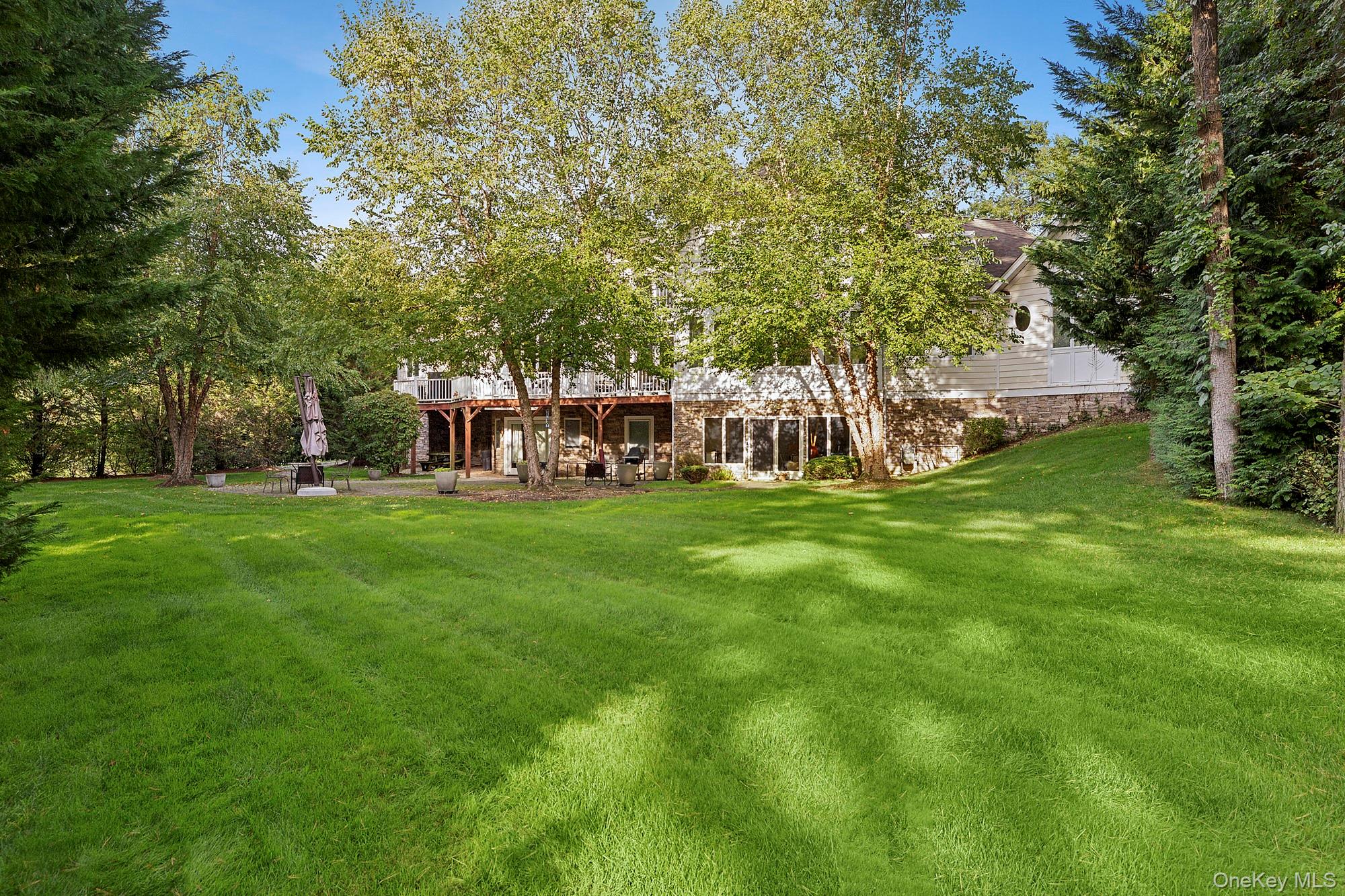 144 Round Swamp Road West Hills, NY 11743 - Photo 9 of 39 Back of property featuring a lawn and a patio area