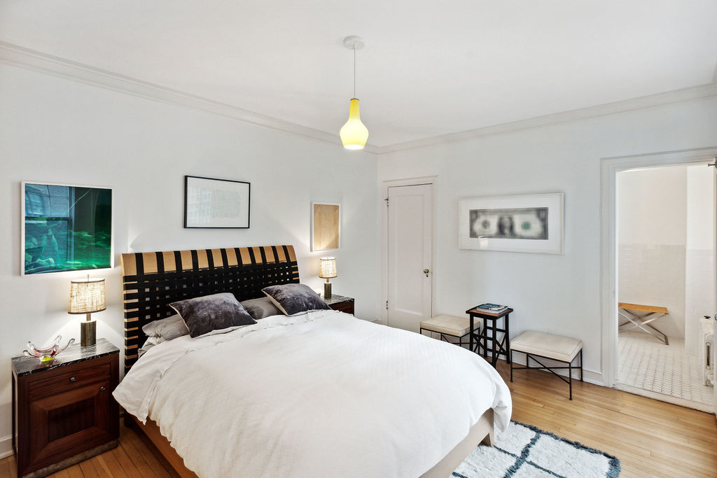 415 West Aldine Avenue, Unit 9D Chicago, IL 60657 - Photo 18 of 32 a bedroom with a bed and wooden floor