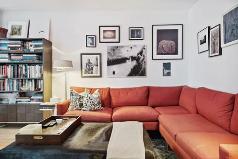 a living room with furniture and book shelf