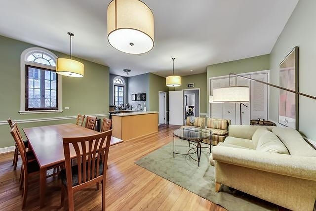 415 West Aldine Avenue, Unit 9D Chicago, IL 60657 - Photo 27 of 32 a view of a dining room with furniture window and wooden floor