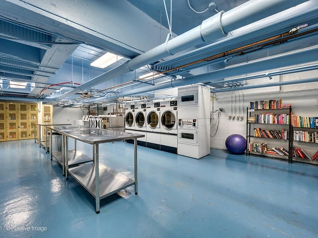 415 West Aldine Avenue, Unit 9D Chicago, IL 60657 - Photo 30 of 32 a view of a room with wooden shelves