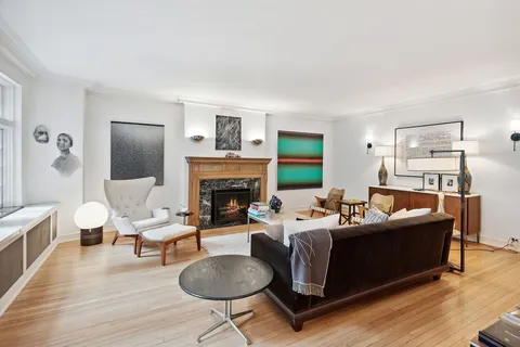 a living room with fireplace furniture and a wooden floor