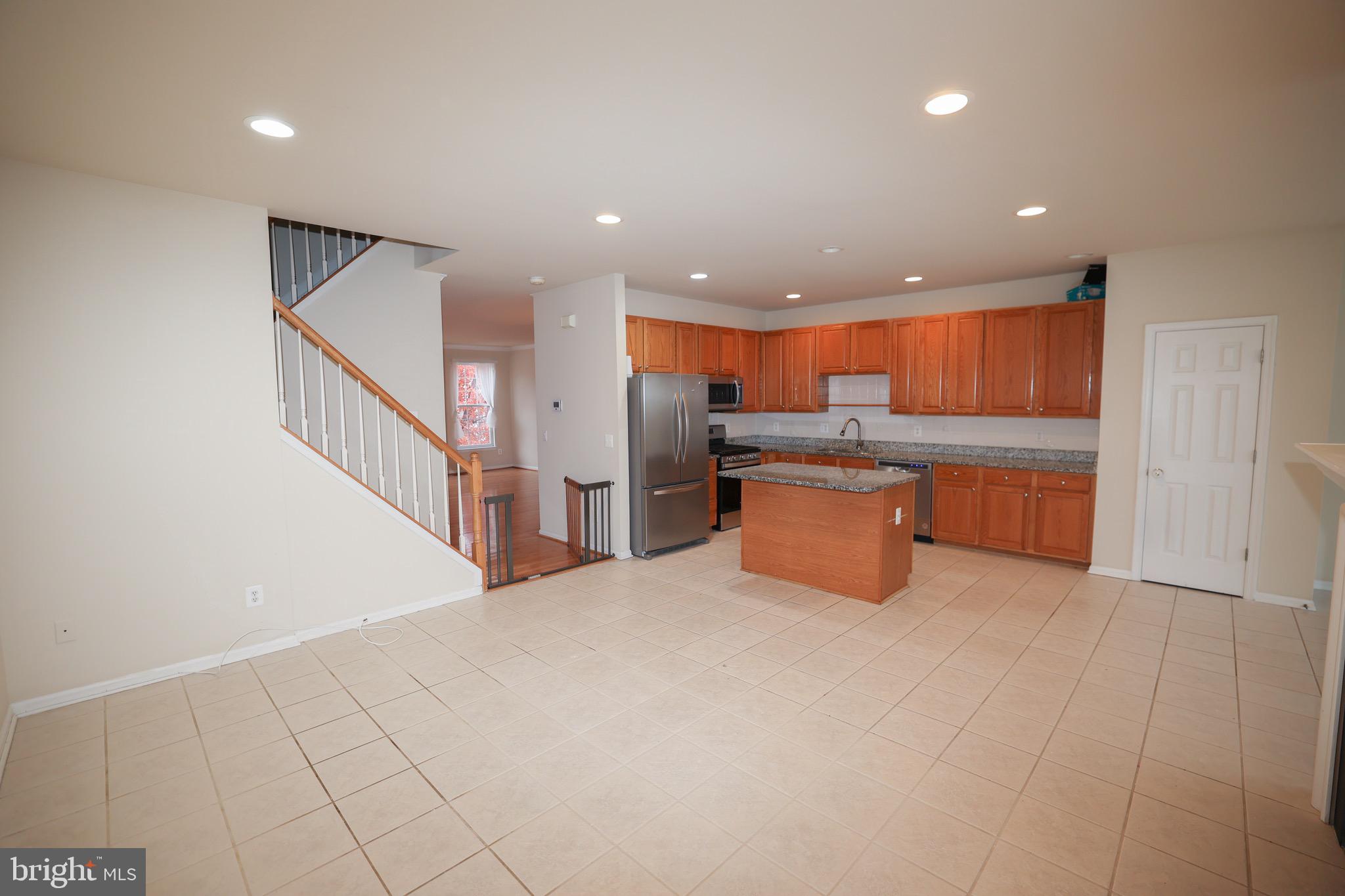 20840 Miranda Falls Square Sterling, VA 20165 - Photo 7 of 17 a kitchen with stainless steel appliances granite countertop a refrigerator and a sink