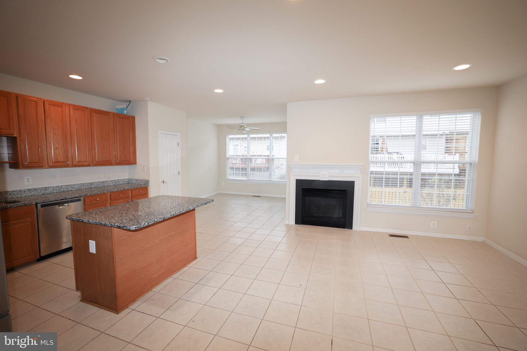 20840 Miranda Falls Square Sterling, VA 20165 - Photo 8 of 17 a kitchen with stainless steel appliances granite countertop a stove a sink and a microwave
